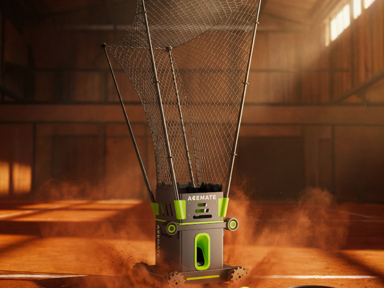 Acemate tennis ball machine on a clay court with tennis balls and a racket nearby